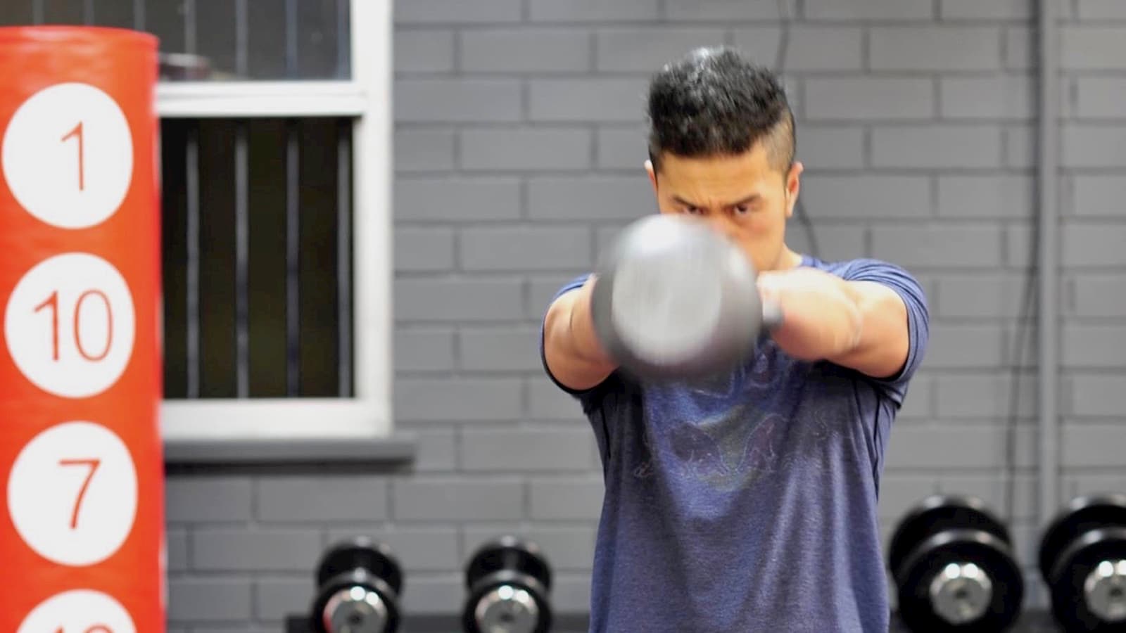 Vu swinging a kettlebell